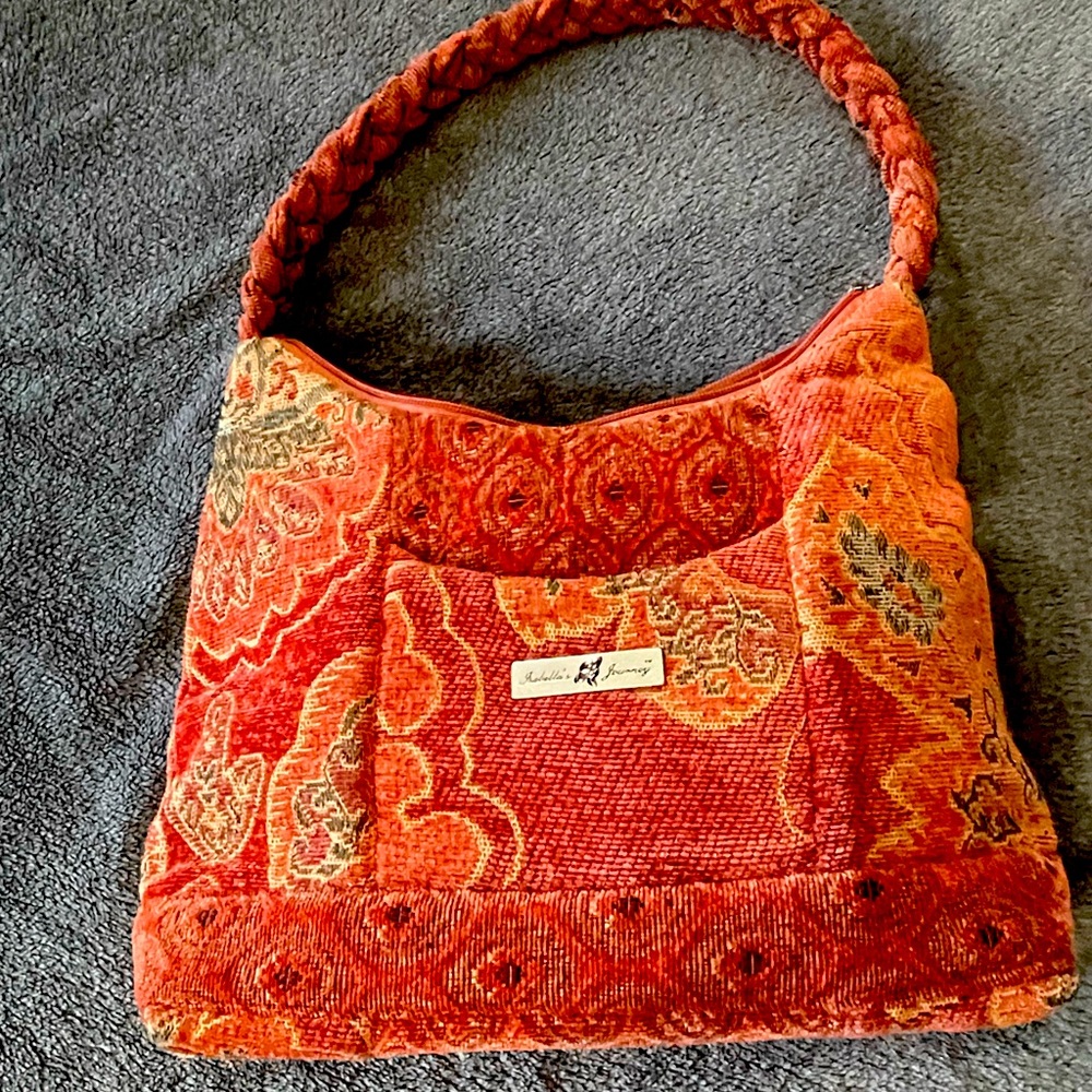 Rust colored Isabella’s Journey braided top handle bag